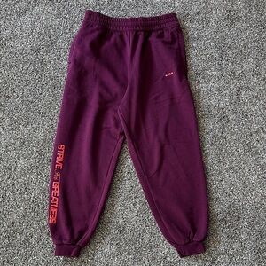 Nike Kids Joggers in Purple with Orange Text